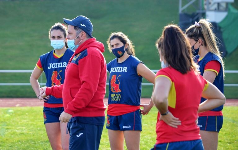 Spain coach talks to his players during a training session